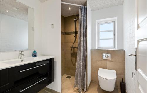 a bathroom with a sink and a toilet and a window at Nice Home In Tim With House A Panoramic View in Halkær