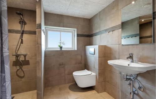 a bathroom with a toilet and a sink at Lovely Home In Tim With Sauna in Halkær