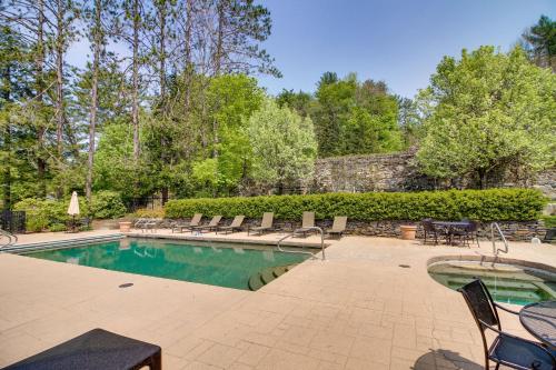 a swimming pool with chairs and a table at Castle Hill Resort Condo 5 Mi to Slopes at Okemo! in Proctorsville