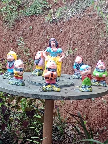 a group of figurines sitting on top of a table at Chalés do Apolinário in Tiradentes