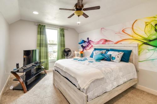 a bedroom with a bed with a painting on the wall at Pet-Friendly Davenport Home - Near Casino and Golf in Davenport
