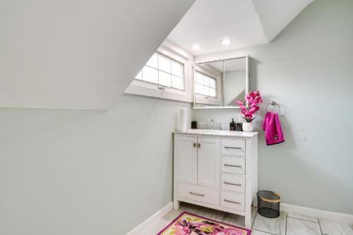 a white bathroom with a sink and a mirror at Pet-Friendly Davenport Home - Near Casino and Golf in Davenport