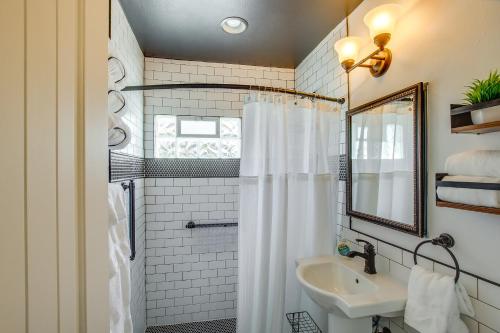 a bathroom with a sink and a shower with a mirror at Sturgeon Bay Home about 6 Mi to Potawatomi State Park in Sturgeon Bay
