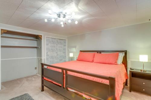 a bedroom with a bed with red pillows on it at 8 Mi to Dtwn Denver Wheat Ridge Gem with Patio in Wheat Ridge