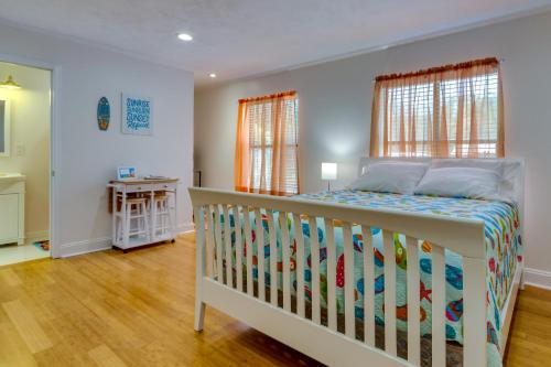 a bedroom with a crib in a room at Gulf Breeze Vacation Rental with Pool Access! in Gulf Breeze