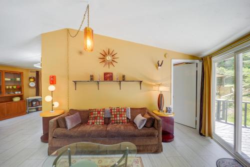 a living room with a couch and a table at Quaint Vacation Rental with Porch in Banner Elk! in Banner Elk