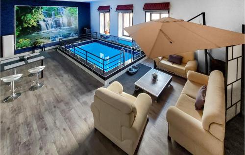 an overhead view of a living room with a swimming pool at Gorgeous Apartment In Saint-Bonnet-Le-Châtea in Saint-Bonnet-le-Château