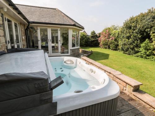a jacuzzi tub in the backyard of a house at The Croft in Alnwick