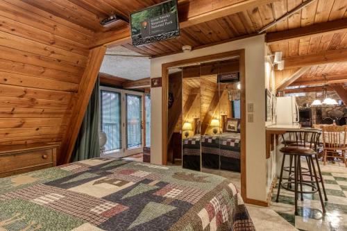 a bedroom with a bed in a room with wooden walls at Mountain Springs Chalet in Gatlinburg