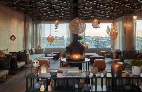 a lobby with a fireplace in the middle of a room at Downtown Camper by Scandic in Stockholm