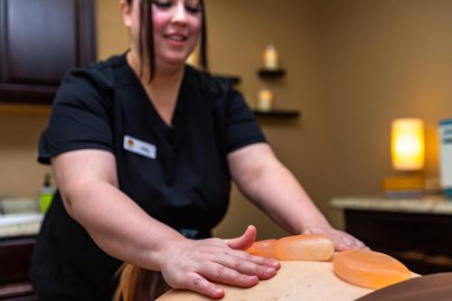 a woman cutting up carrots on a cutting board at Scottsdale Camelback Resort in Scottsdale
