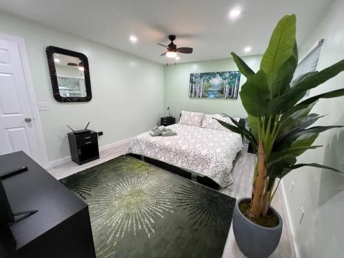 a bedroom with a bed and a potted plant at Tranquility in paradise- 2 bedroom villa w/parking in Hilton Head Island