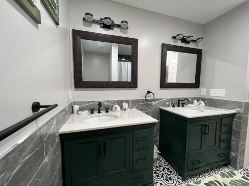 a bathroom with two sinks and a mirror at Tranquility in paradise- 2 bedroom villa w/parking in Hilton Head Island
