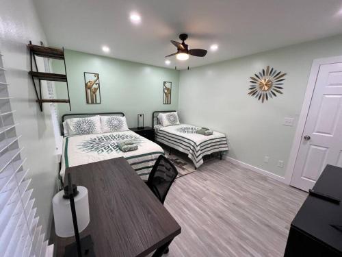 a room with two beds and a table in it at Tranquility in paradise- 2 bedroom villa w/parking in Hilton Head Island