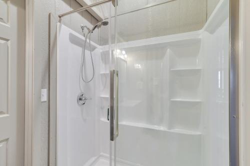 a shower with a glass door in a bathroom at Scenic Ranch House with Fishing Pond! 