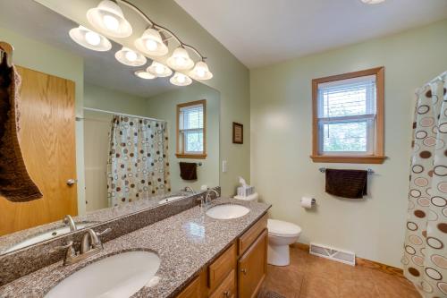 a bathroom with two sinks and a toilet at Cottage in Edinboro Walk to Pat Crawford Beach! in Edinboro