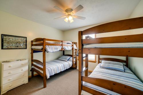 a bedroom with two bunk beds and a ceiling fan at Cottage in Edinboro Walk to Pat Crawford Beach! in Edinboro