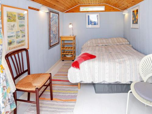 a bedroom with a bed and a chair and a table at 6 person holiday home in Otterup-By Traum in Otterup
