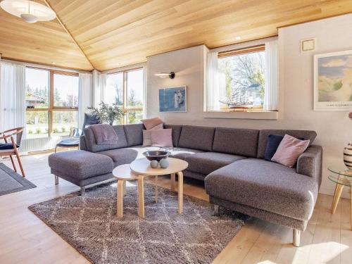 a living room with a couch and a table at 8 person holiday home in Skagen in Skagen