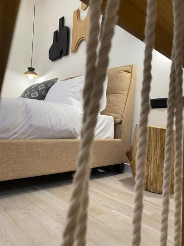 a bedroom with a bed and a chair at Olea White in Skiathos Town