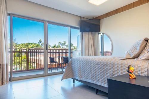 a bedroom with a bed and a balcony at ILE de Pipa Resort Quarto Superior Frente Piscina in Pipa