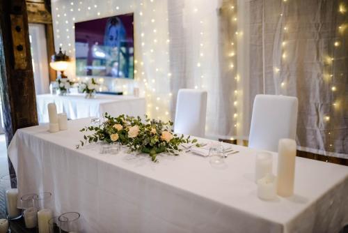 a white table with candles and flowers on it at Northridge Golf Resort in Orewa