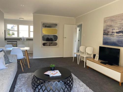 a living room with a couch and a tv at Lovely Newly Renovated Home in Hamilton