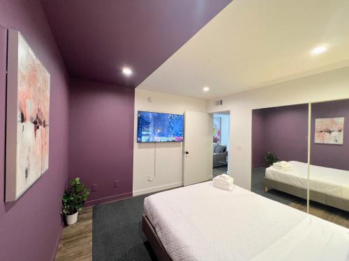 1 dormitorio con paredes moradas y 1 cama en él en Hollywood Purple Habitat en Los Ángeles