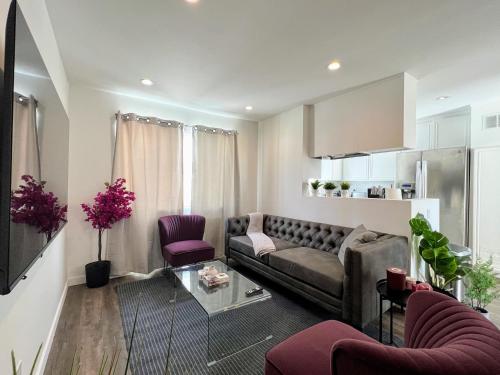 a living room with a couch and purple chairs at Hollywood Purple Habitat in Los Angeles