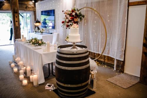 a table with a cake on top of a wine barrel at Northridge Golf Resort in Orewa
