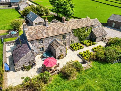 an overhead view of a large stone house with an umbrella at Sweet Knoll Farm in Peak Forest