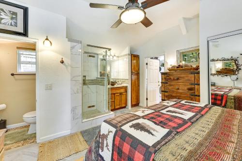 a bedroom with a bed and a shower and a toilet at Cozy Forest Falls Rental Cabin Near Hiking Trails! in Forest Falls