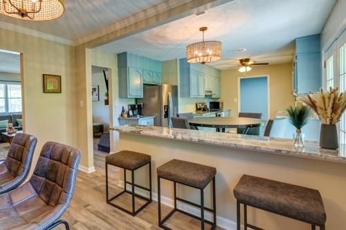a kitchen and living room with a counter and chairs at Cozy High Point Vacation Rental Near HPU Campus in High Point