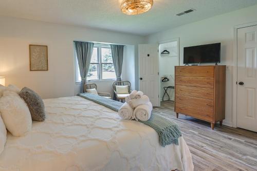 a bedroom with a large bed with towels on it at Cozy High Point Vacation Rental Near HPU Campus in High Point