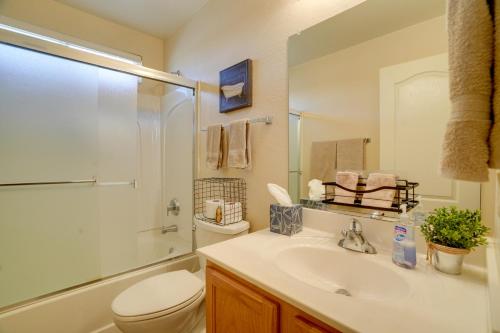 a bathroom with a sink and a toilet and a shower at Pool, Patio and Hot Tub Surprise Home Near Golfing! in Surprise