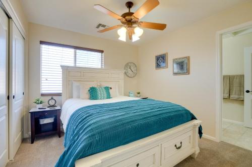 a bedroom with a bed with a ceiling fan at Pool, Patio and Hot Tub Surprise Home Near Golfing! in Surprise