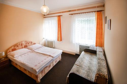 a bedroom with two beds and a window at Ubytování u Nováků in Malá Morávka
