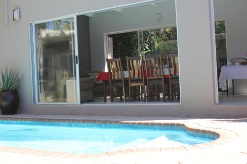 a swimming pool in front of a house at Olive Tree B&B in Upington