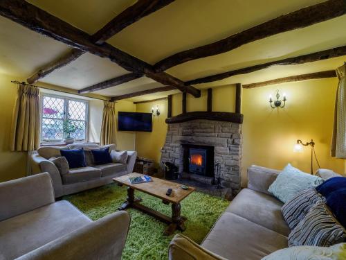 a living room with couches and a fireplace at Sweet Knoll Farm in Peak Forest