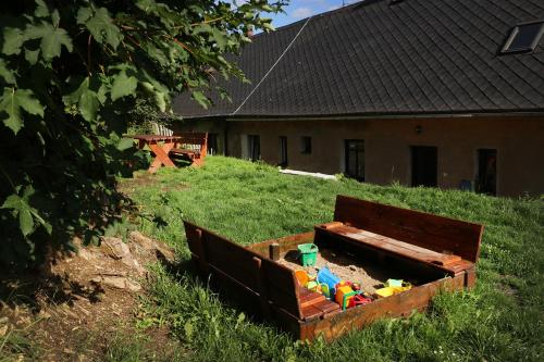 a wooden box filled with toys in a yard at Ubytování u Nováků in Malá Morávka