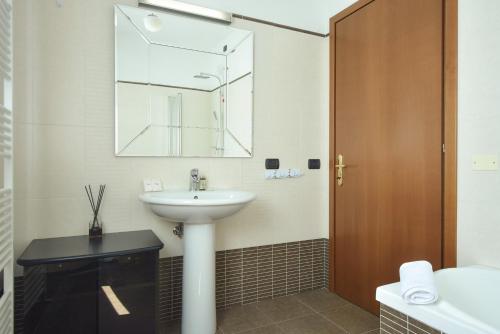 a bathroom with a sink and a mirror at Villafranca Relaxing apartment in Villafranca Padovana