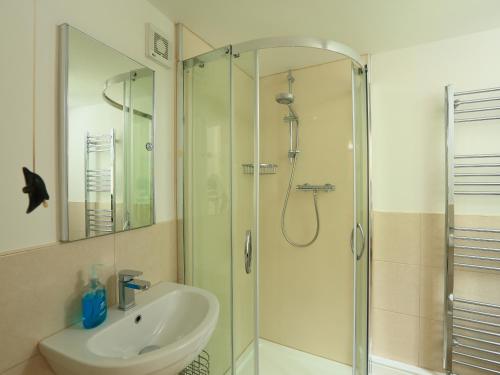 a bathroom with a glass shower and a sink at Ferry View in Dartmouth