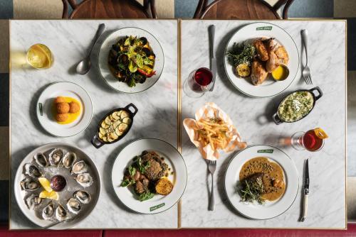a table with plates of food on top of it at Palihotel San Diego Gaslamp Quarter in San Diego
