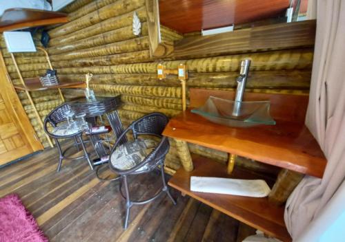 a room with tables and chairs in a log cabin at Pousada do Xerife in Caconde