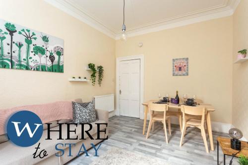 a living room with a table and a couch at Brunswick road Lovely 2 Bed Apartment in Edinburgh