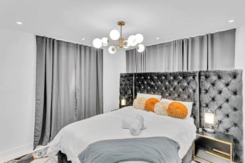 a bedroom with a large bed with orange pillows at Luxury Hollywood Home, Heated Pool, Casino Nearby in Hollywood