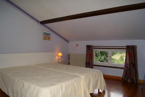 a bedroom with a white bed and a window at Durand Yves in Régnié