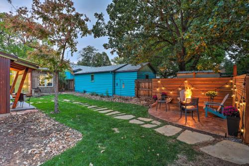 a backyard with a table and chairs and a fence at Fort Collins Vacation Rental with Private Hot Tub! in Fort Collins