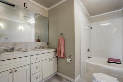 a white bathroom with a sink and a toilet at Come experience the Sunsets ! in San Francisco