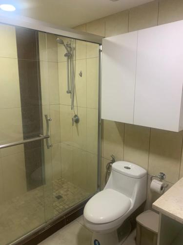 a bathroom with a toilet and a glass shower at Puerto Santa Ana, Torres Bellini, 2 dormitorios, Parqueo in Guayaquil